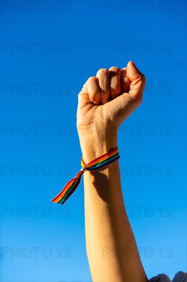 Hand of a woman with closed fist in favor of feminism