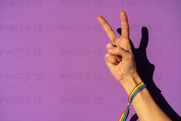 Hand of a woman with victory symbol in favor of feminism