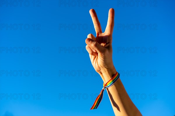 Hand of a woman with victory symbol in favor of feminism