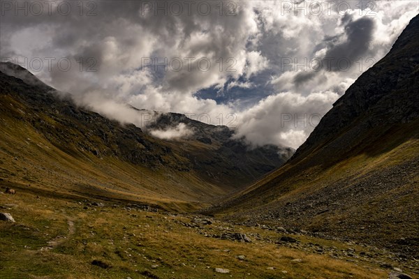 Val Minor in autumn colours with dramatic cloudy sky