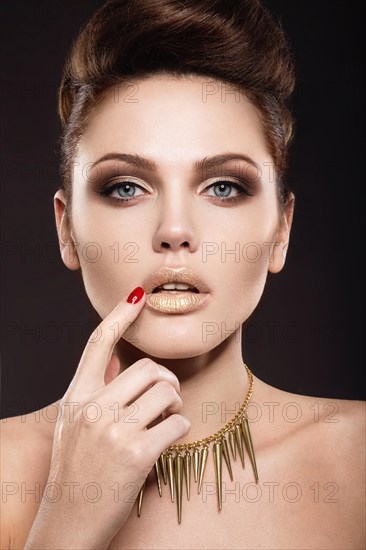 Beautiful girl with a gold accessories