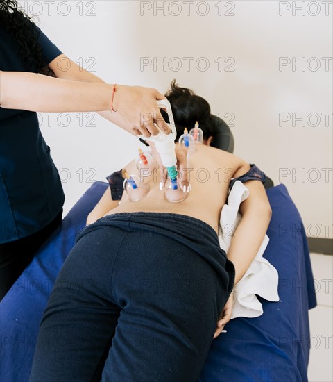 Physiotherapist Applying Cupping Techniques on patient
