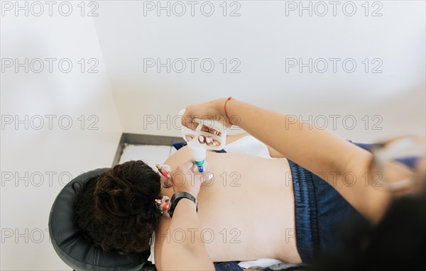 Professional physiotherapy treatment with cupping on a lying patient