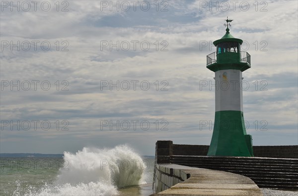 Waves splash against the pier of Sassnitz lighthouse