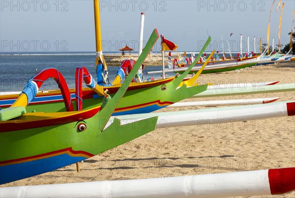 Brightly painted fishing outriggers on the beach at Sanur