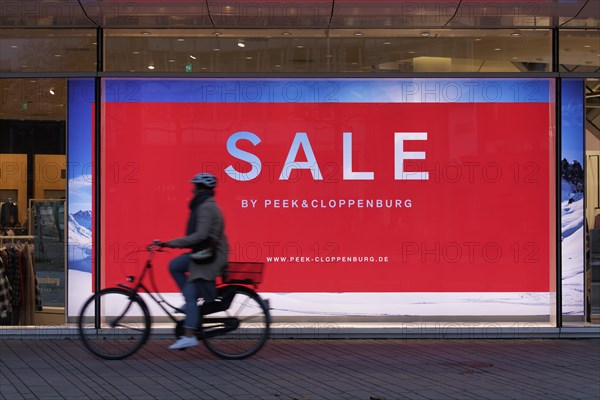 Illuminated shop window with poster Sale