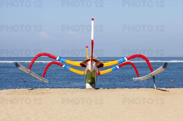 Brightly painted fishing outriggers on the beach at Sanur