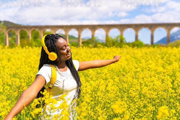 Listening to music in yellow headphones with closed eyes