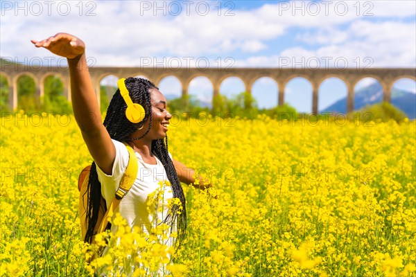 Dancing to music in yellow headphones with closed eyes