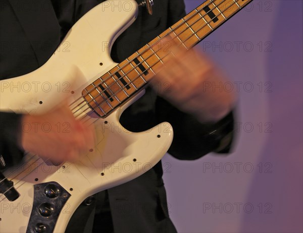 Jazz bassist slaps an electric bass