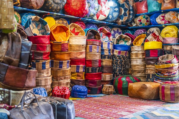 Variety of leather poufs sold in huge shop next to tannery in Fes