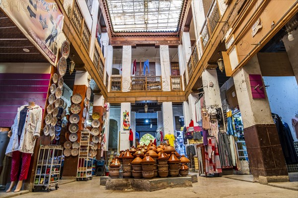 Shop in the courtyard with traditional tajine pot in the middle