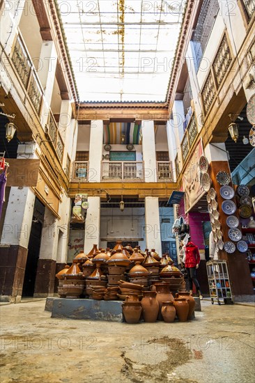 Shop in the courtyard with traditional tajine pot in the middle