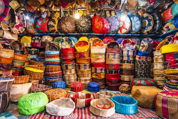 Variety of leather poufs sold in huge shop next to tannery in Fes