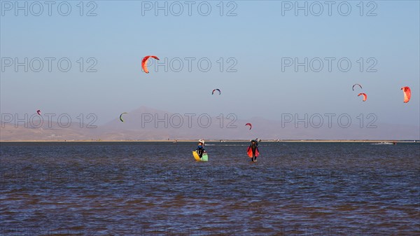 Several kitesurfers