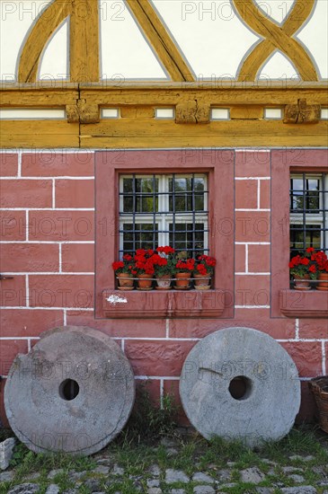 Two millstones in front of the mill