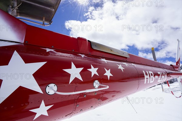 Swiss helicopter tail close up side view with red and white stars on chassis