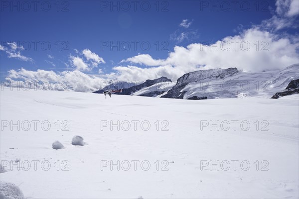 Red and white Swiss helicopter parks on Aletsch Glacier