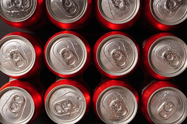 Group of fresh beer cans with drops of water with black background