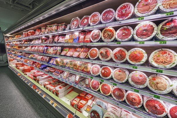 Shelf with sausages packed in plastic in a wholesale market