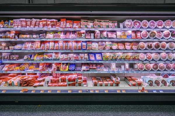 Shelf with sausages packed in plastic in a wholesale market