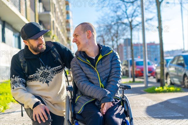 A disabled person in a wheelchair with a friend smiling