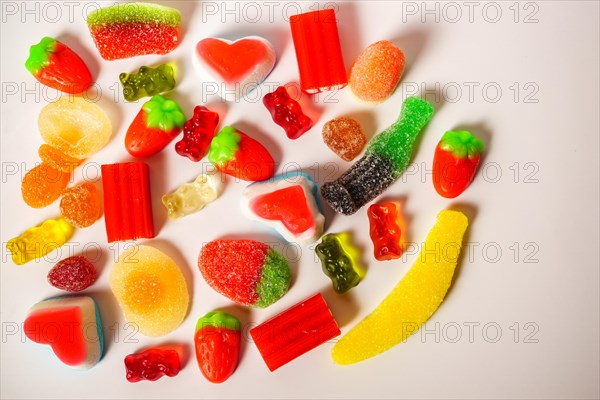 Various types of assorted jelly candy on white background