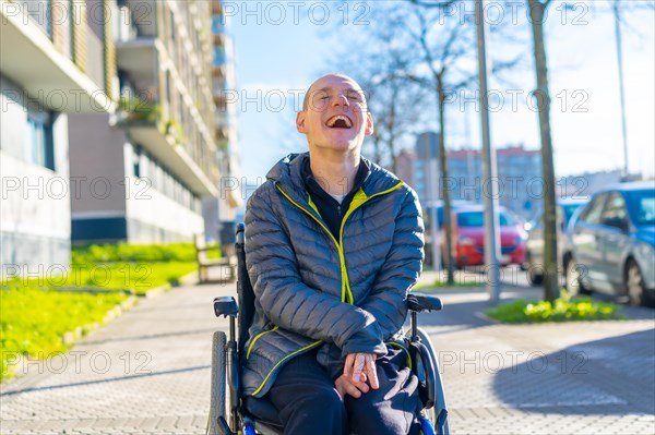 A disabled person enjoying walking on the street in a wheelchair