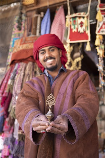 Jordanian Bedouin with traditional eyeliner shows a bronze vial with AlKuhl