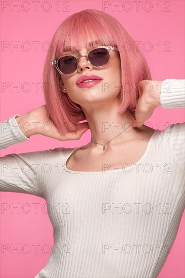 Beautiful funny cute woman in pink wig and classic makeup