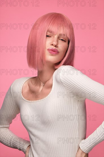 Beautiful funny cute woman in pink wig and classic makeup