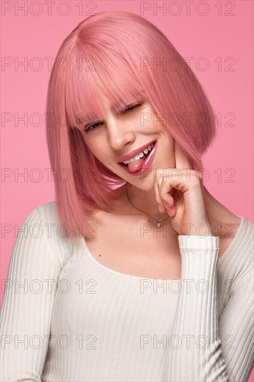 Beautiful funny cute woman in pink wig and classic makeup