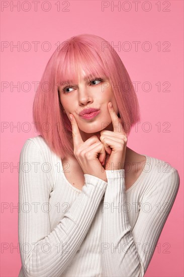 Beautiful funny cute woman in pink wig and classic makeup