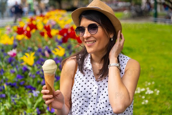A tourist woman visiting the city eating a pistachio ice cream