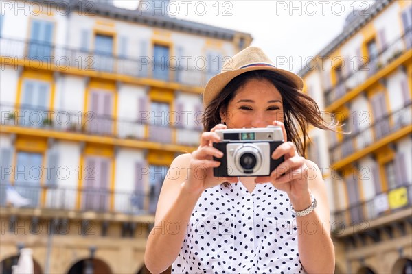 Tourist woman enjoying visiting the city taking photos of the trip