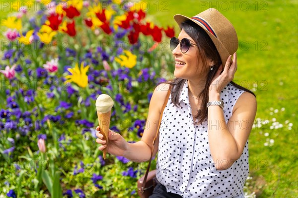 Tourist woman enjoying visiting the city eating a pistachio ice cream