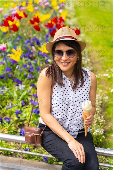 Tourist woman enjoying visiting the city eating a pistachio ice cream