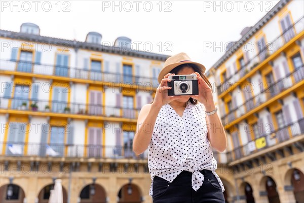 Tourist woman enjoying visiting the city taking photos of the trip