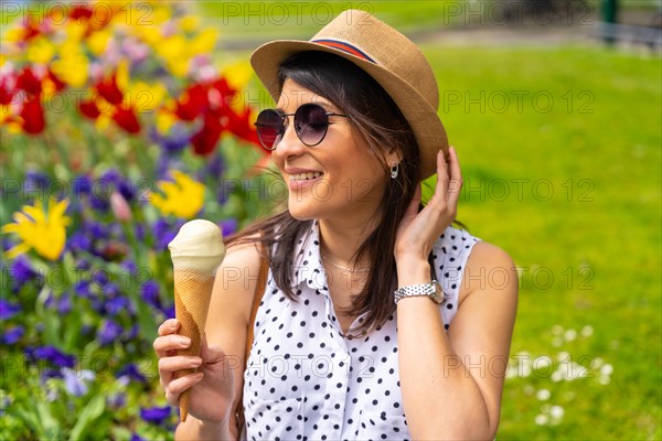Tourist woman enjoying visiting the city eating a pistachio ice cream