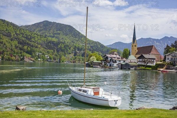 Church of St Laurentius and sailing boat with Tegernsee