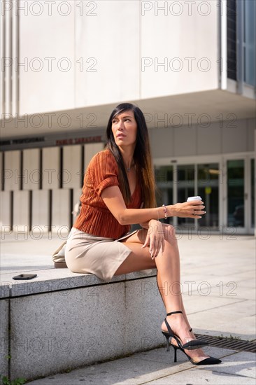 Portrait of a businesswoman outside the office with a coffee in her hand