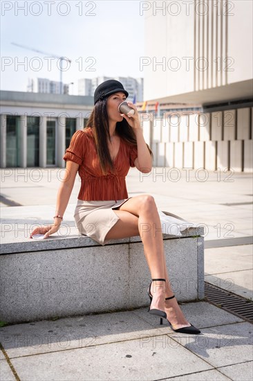 Portrait of a businesswoman outside the office having a hot coffee