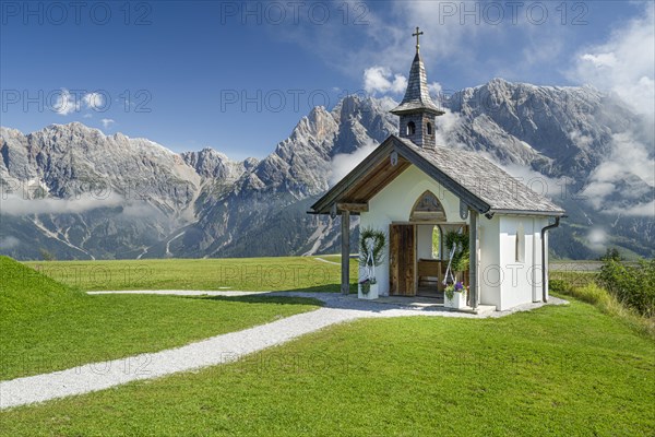 Chapel in front of mountain scenery