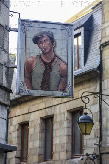 Sign of a clothing shop with portrait of young man in vest with tie