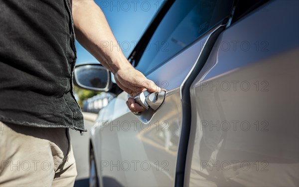 Hands opening the car door