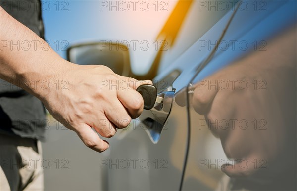 Hands with keys opening the car door