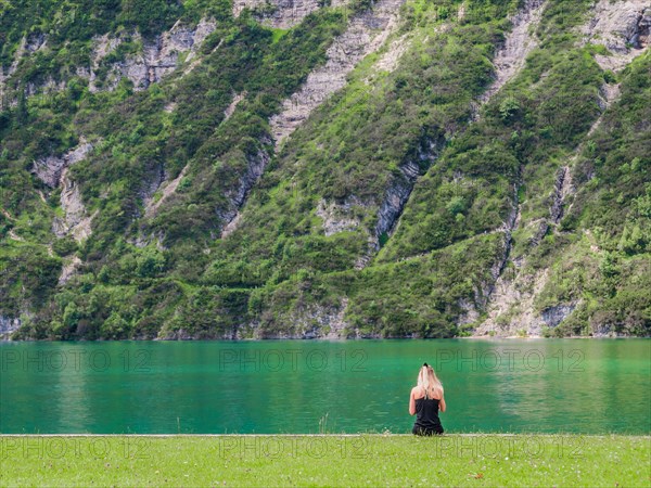 Young girl sitting at the shore of Achensee