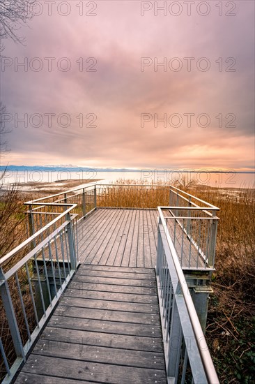 Viewing platform in the moor at the lake at sunset