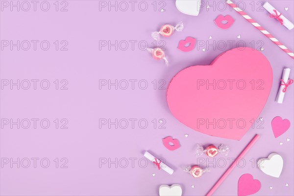 Pastel colored Valentine's Day flat lay with heart shaped gift box
