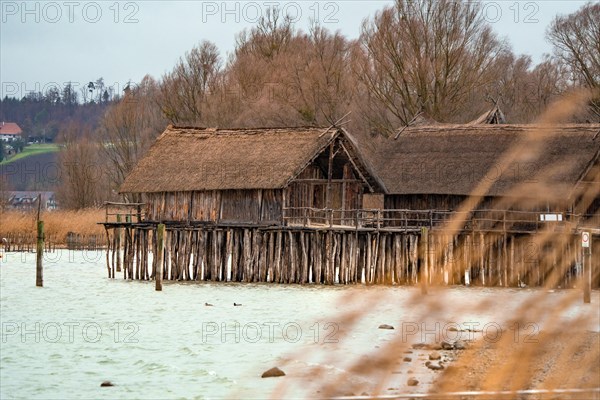 Historic lake dwelling huts in the Lake Dwelling Museum in gloomy weather